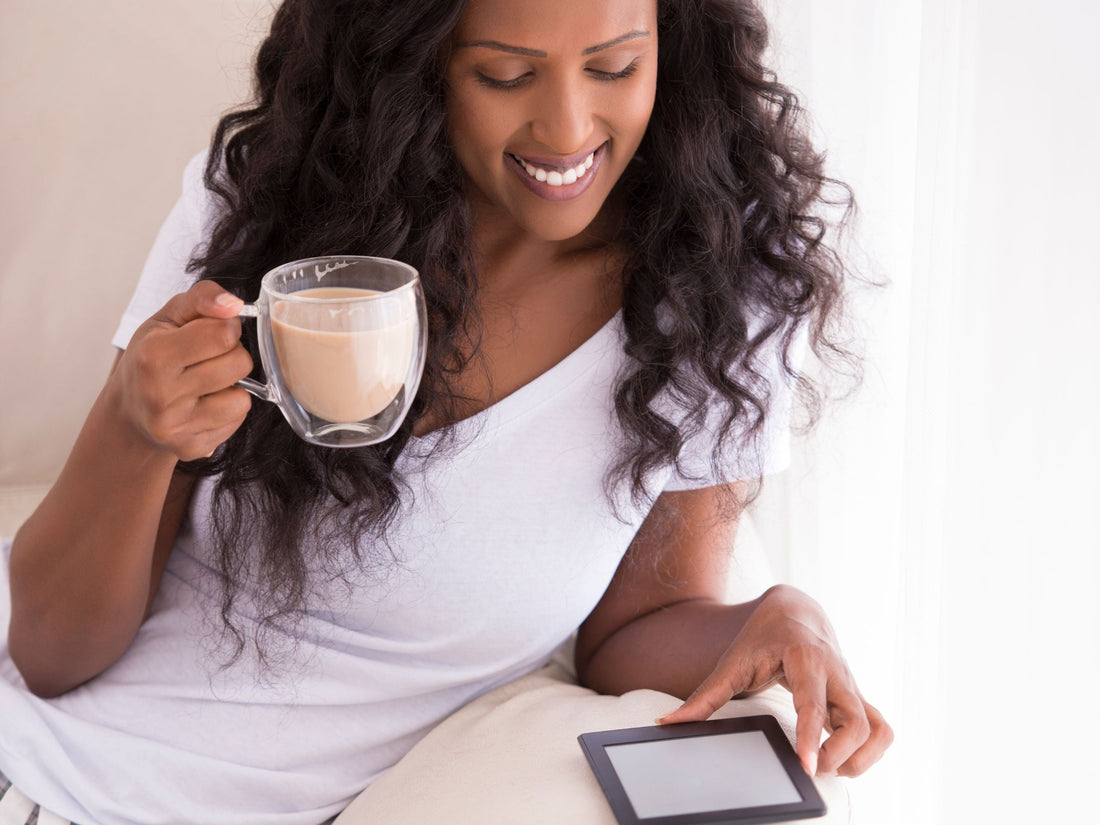 Solopreneur enjoying coffee while reading on a digital tablet, representing balance and digital entrepreneur lifestyle.